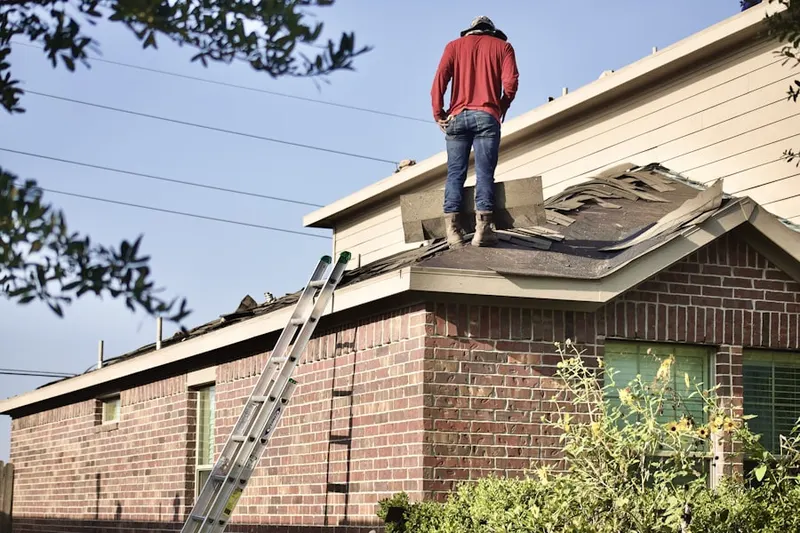 Professional roofer working on a residential roof in Vista Ridge Village